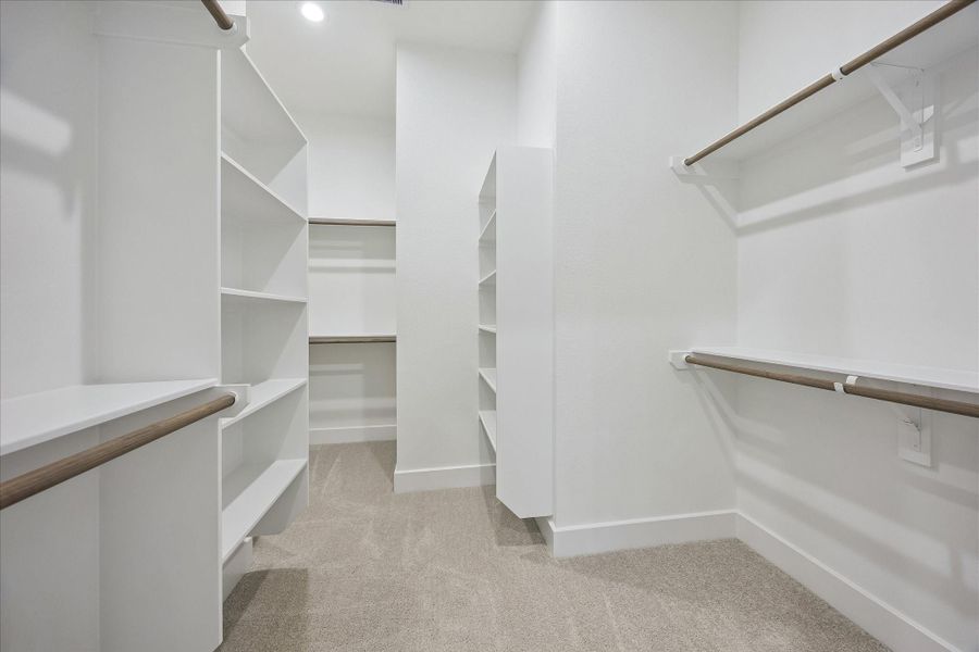 The impressive walk-in closet offers abundant hanging space and built-in shelving for effortless organization. The impressive walk-in closet offers abundant hanging space and built-in shelving for effortless organization.