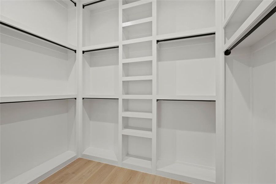 Walk in closet featuring wood finished floors