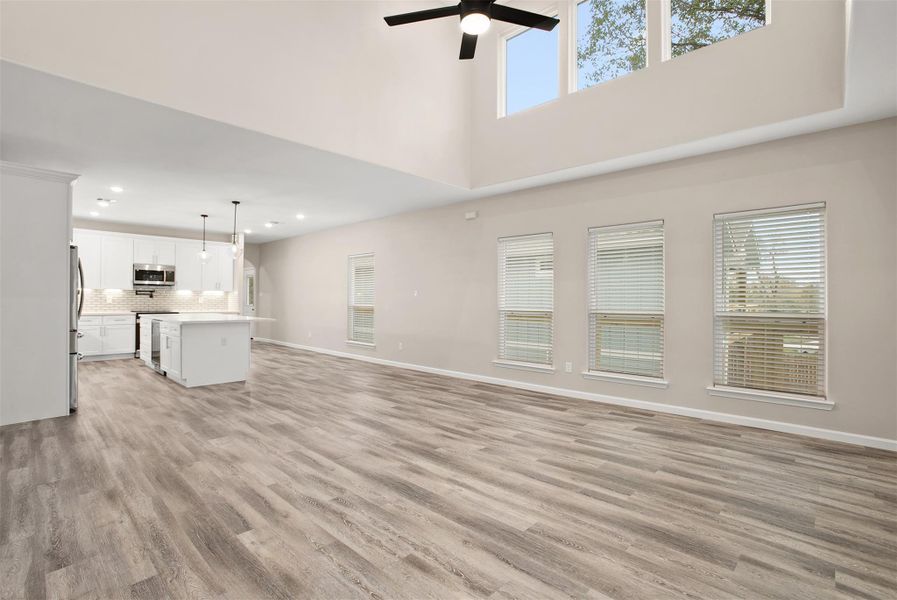 Large living area with 20 ft ceiling and skylight