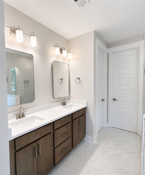 Dual vanities with ample storage offer both functi