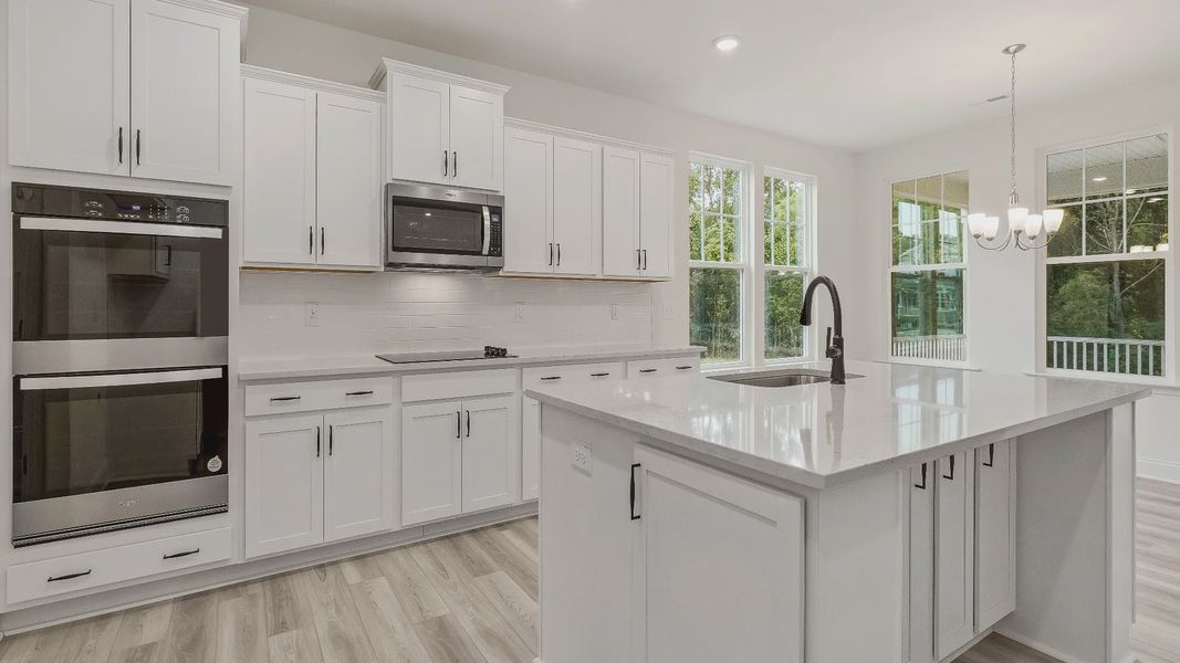 Stonehaven home plan kitchen with large island, ample cabinetry and butler's pantry with adjoining breakfast area