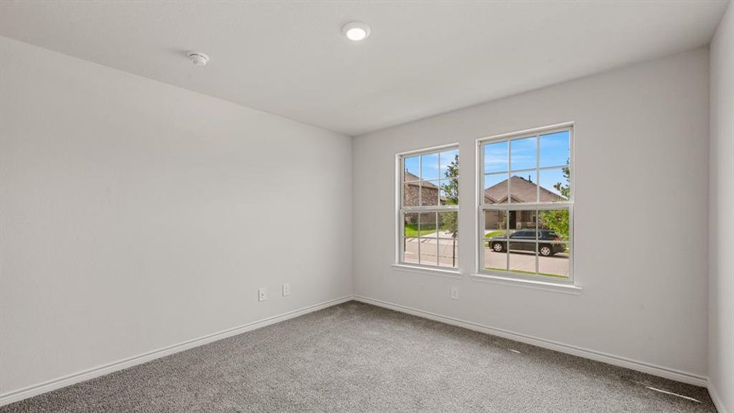 Interior room with light gray carpet flooring and white baseboards Interior room with light gray carpet flooring and white baseboards