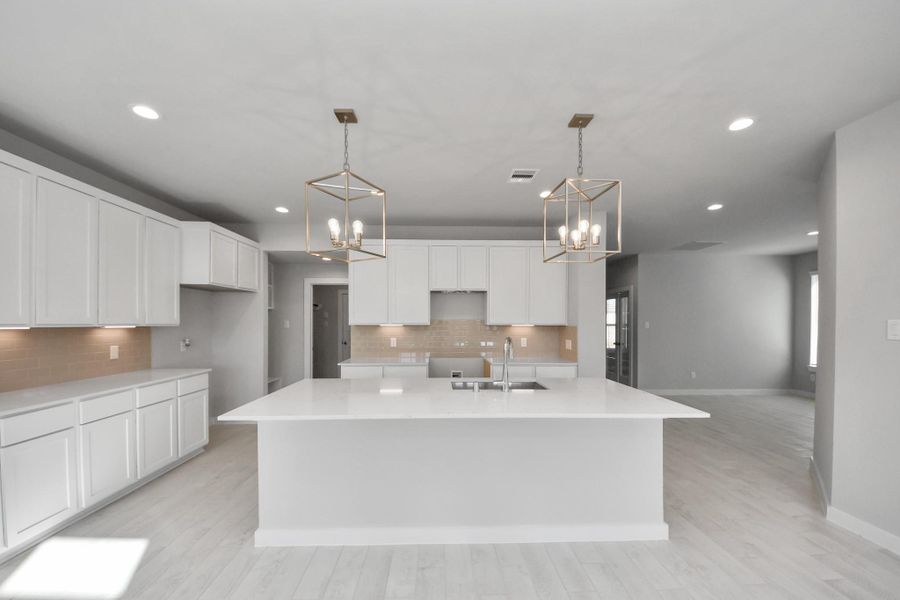 This kitchen is by far any chef’s dream! This spacious kitchen features high ceilings, light stained wood cabinets, granite countertop, SS appliances, modern tile backsplash, recessed lighting, extended counter space, granite kitchen island with double sink, and space for breakfast bar, and a walk-in pantry all overlooking your huge family room. Sample photo of completed home with similar floor plan. Actual colors and selections may vary. This kitchen is by far any chef’s dream! This spacious kitchen features high ceilings, light stained wood cabinets, granite countertop, SS appliances, modern tile backsplash, recessed lighting, extended counter space, granite kitchen island with double sink, and space for breakfast bar, and a walk-in pantry all overlooking your huge family room. Sample photo of completed home with similar floor plan. Actual colors and selections may vary.