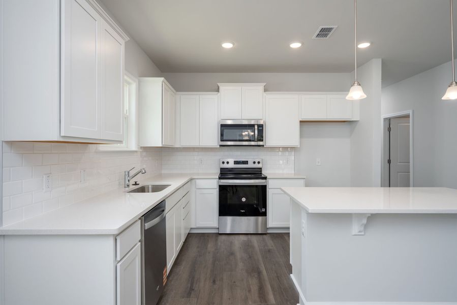 Open Kitchen with white cabinets and granite countertops. Open Kitchen with white cabinets and granite countertops.