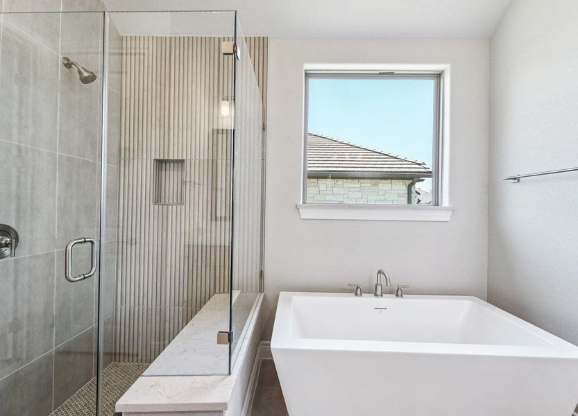 Full bathroom featuring a freestanding tub and a shower stall