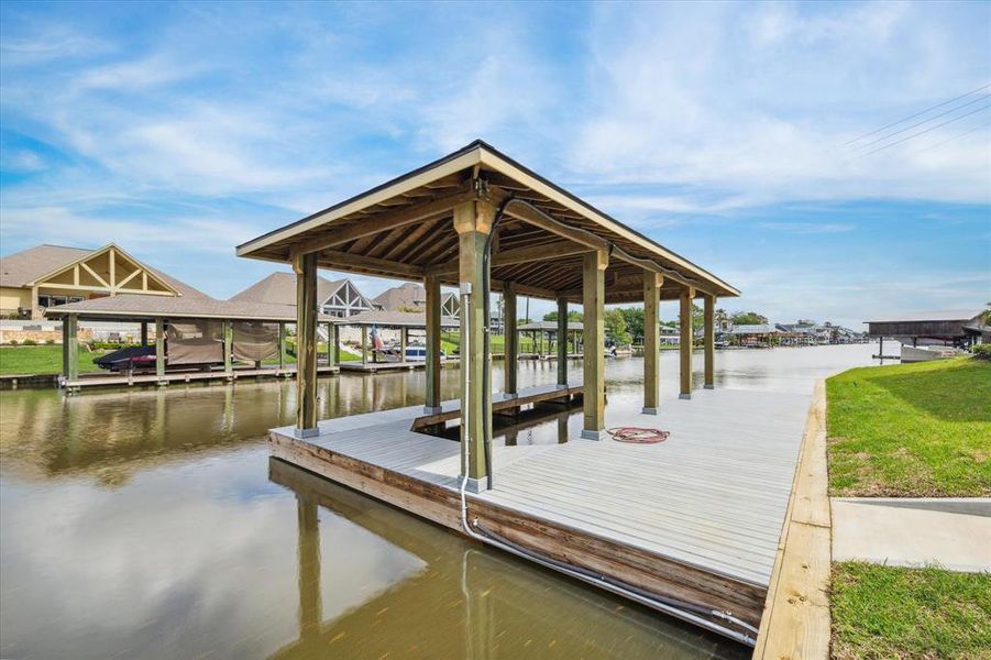 This is a waterfront property featuring a spacious 40' boat dock with a covered slip, offering direct access to the waterway.