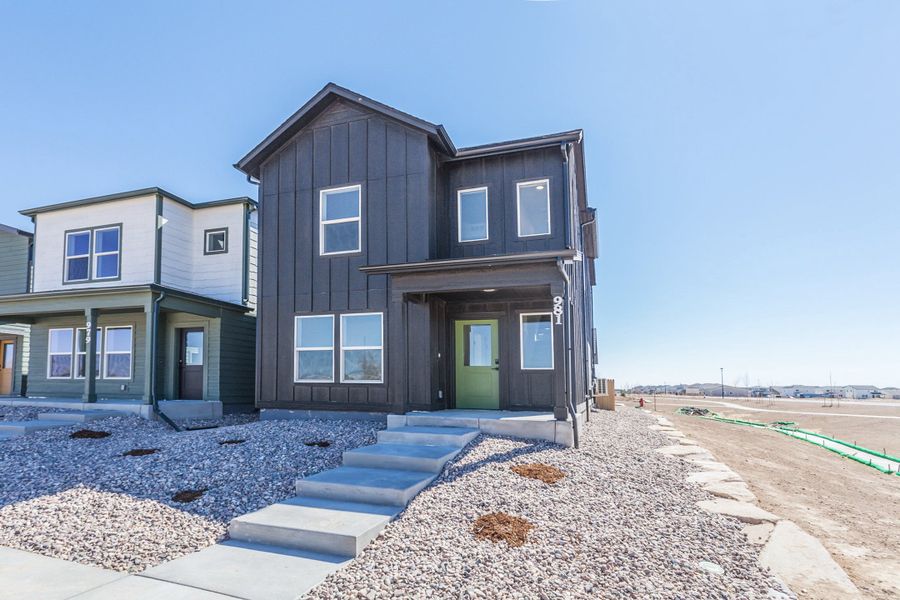 Front exterior of a new home in Prairie Song, Windsor, CO, highlighting curb appeal (Image 27). Front exterior of a new home in Prairie Song, Windsor, CO, highlighting curb appeal (Image 27).