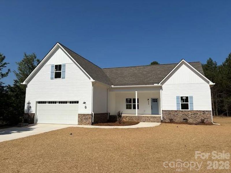 Front exterior of a new home in , Troutman, NC, highlighting curb appeal (Image 17).