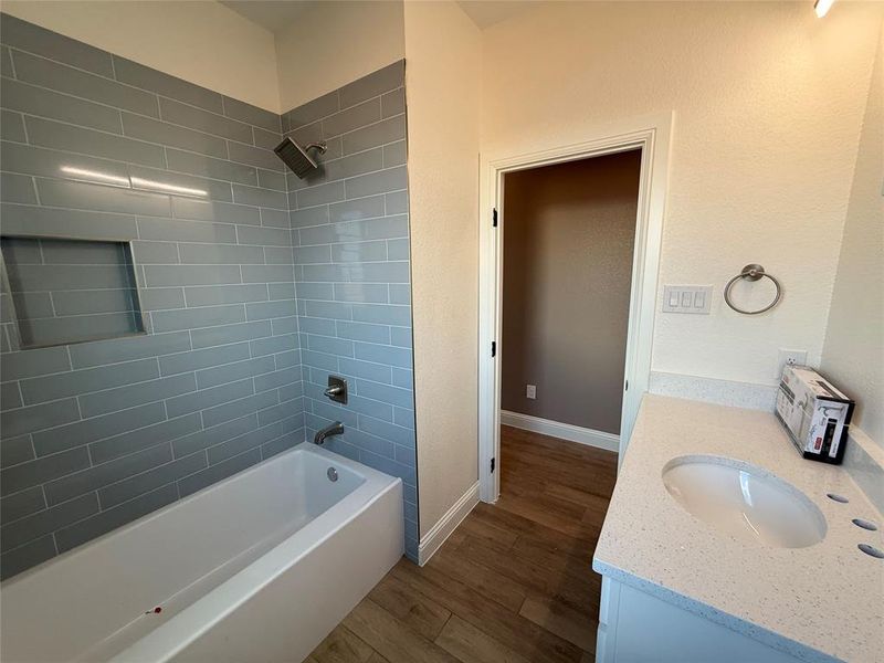 Tiled tub/shower combo in the 2nd hall bath.