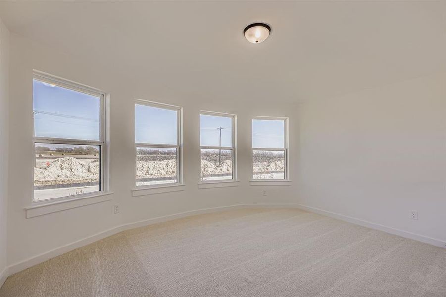Unfurnished room with light colored carpet and baseboards