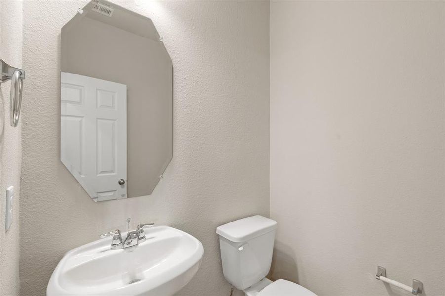 This charming home features a beautifully appointed half bath adjacent to the family room, perfect for welcoming guests and adding convenience to your daily life.