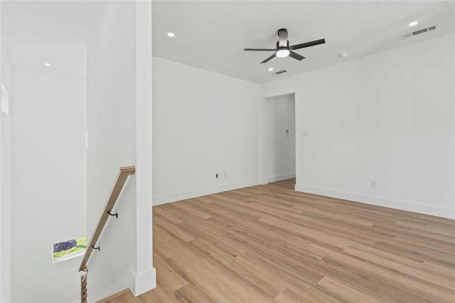 Spare room with light wood finished floors and recessed lighting