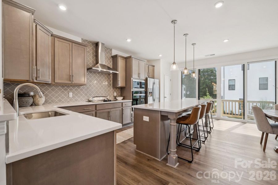 Large island and natural light leading to lovely, cozy balcony