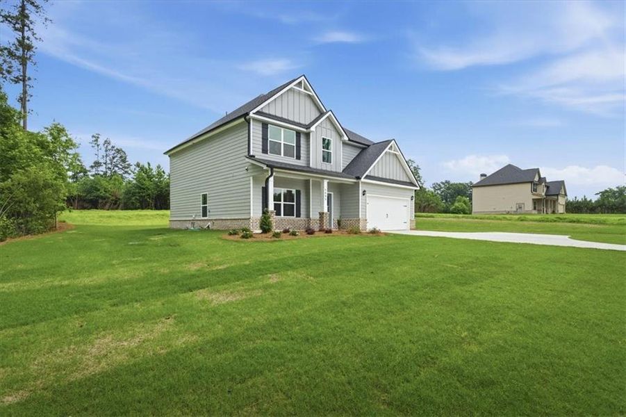 Front exterior of a new home in , Stockbridge, GA, highlighting curb appeal (Image 18). Front exterior of a new home in , Stockbridge, GA, highlighting curb appeal (Image 18).