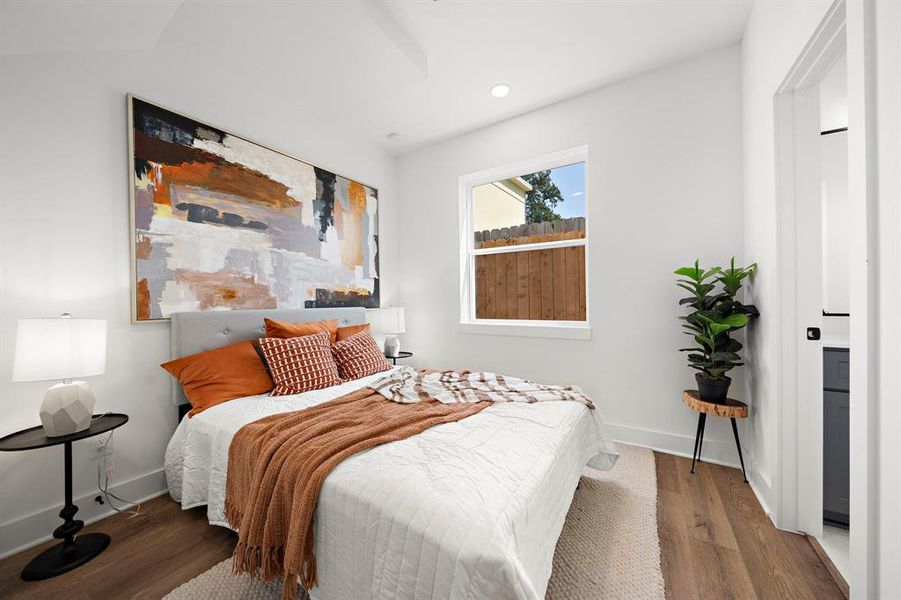 Cozy first-floor bedroom with abundant natural light and modern decor.