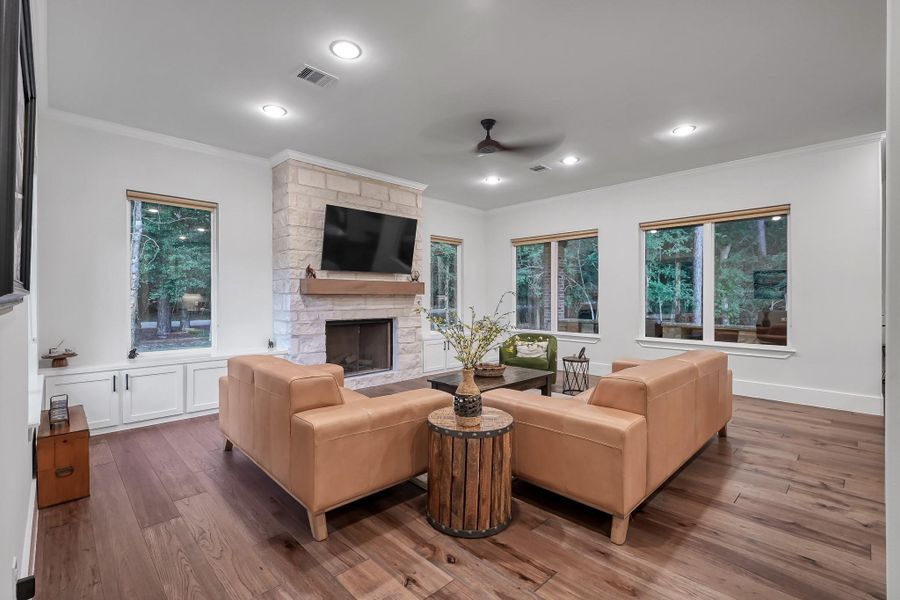 Cozy up in this spacious living room with a charming stone fireplace.