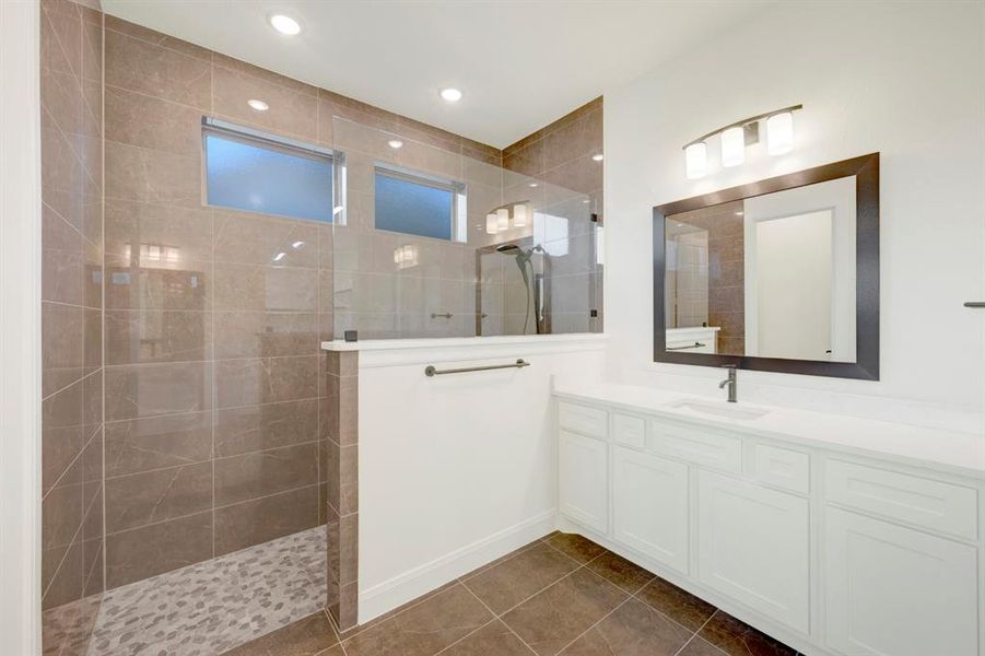 Full bath with vanity, walk in shower, dark tile patterned flooring, and recessed lighting Full bath with vanity, walk in shower, dark tile patterned flooring, and recessed lighting