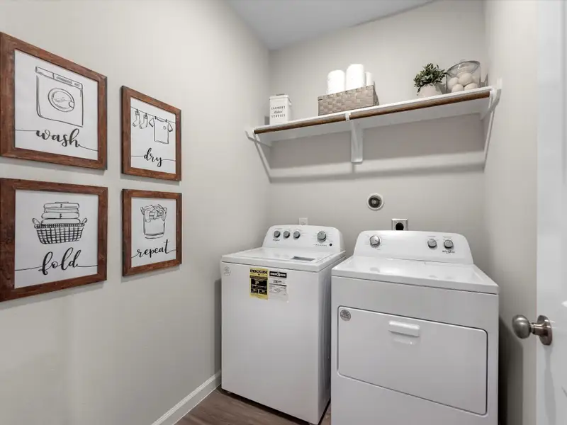 A laundry room with a washer and dryer. A laundry room with a washer and dryer.