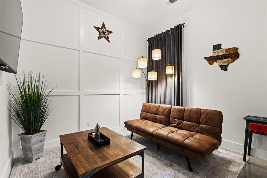 Living area with a decorative wall and baseboards
