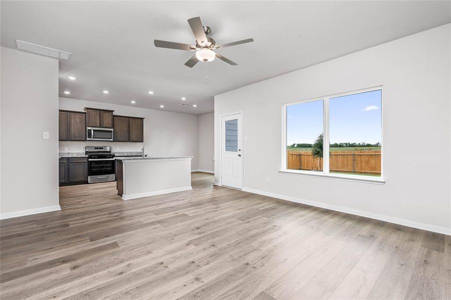 Unfurnished living room with light wood-style flooring, recessed lighting, and ceiling fan Unfurnished living room with light wood-style flooring, recessed lighting, and ceiling fan