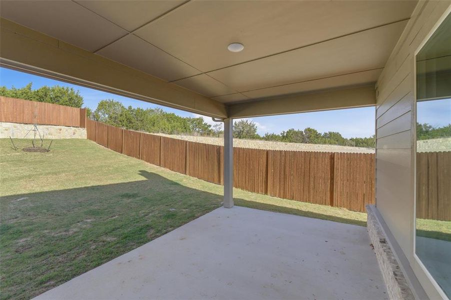 Fenced backyard with a patio area