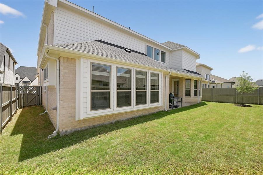Exterior details and patio area of a home in Pecan Square, Northlake (Image 25).