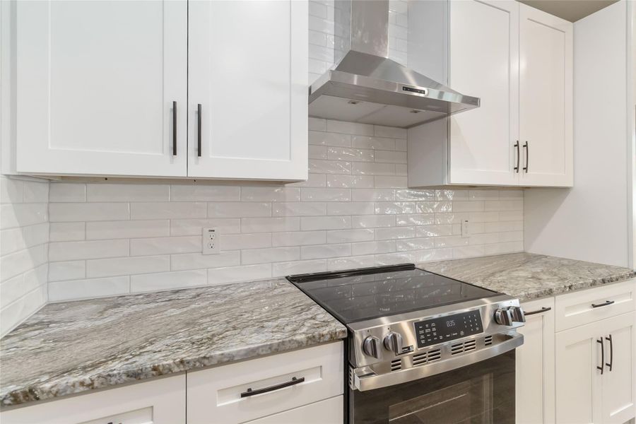 Electric range, granite countertops and viking vent hood