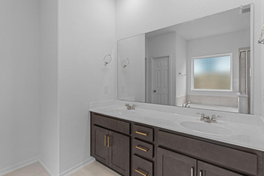 The en-suite bathroom offers a spa-like atmosphere with its elegant design, high end finishes, and tasteful lighting, creating a retreat within your own home. The en-suite bathroom offers a spa-like atmosphere with its elegant design, high end finishes, and tasteful lighting, creating a retreat within your own home.