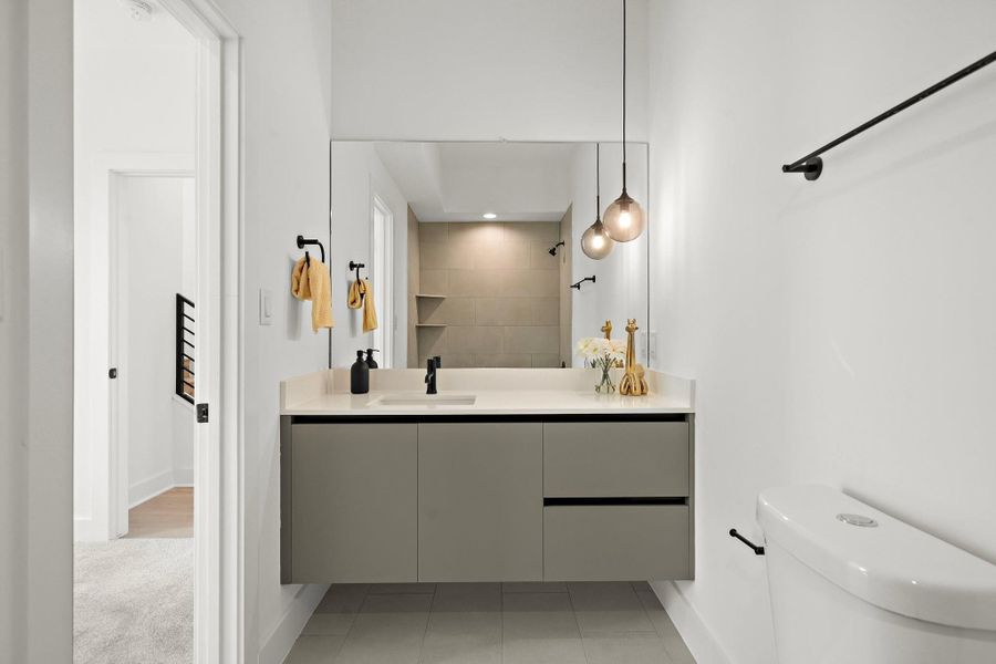 The secondary en suite bathroom in first floor offers a warm, inviting ambiance with tasteful design elements throughout. The secondary en suite bathroom in first floor offers a warm, inviting ambiance with tasteful design elements throughout.