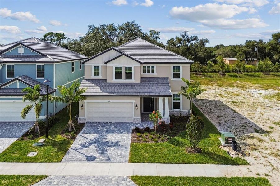 Front exterior of a new home in Hawkstone, Sarasota, FL, highlighting curb appeal (Image 20). Front exterior of a new home in Hawkstone, Sarasota, FL, highlighting curb appeal (Image 20).
