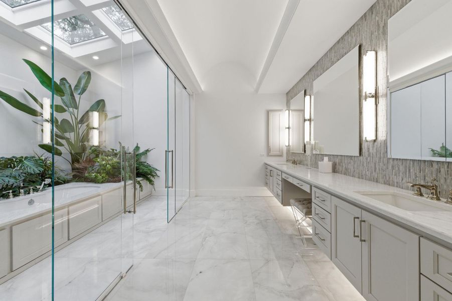 Full bathroom with double vanity, a barrel ceiling, a garden tub, a stall shower, and light marble finish floors