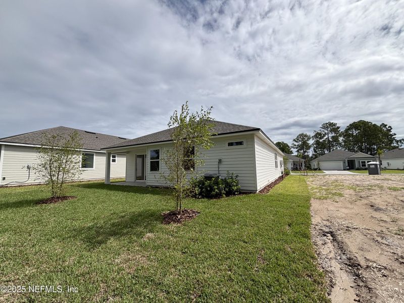 Exterior details and patio area of a home in The Magnolia Series at Reserve East, Flagler Beach (Image 16).