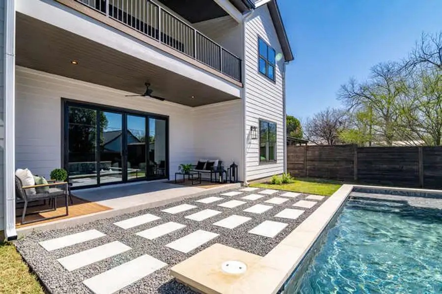 View of swimming pool featuring patio surround, a balcony, and a fenced backyard View of swimming pool featuring patio surround, a balcony, and a fenced backyard