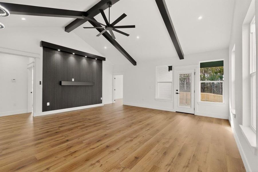 Unfurnished living room with a ceiling fan, light wood-style floors, and recessed lighting Unfurnished living room with a ceiling fan, light wood-style floors, and recessed lighting