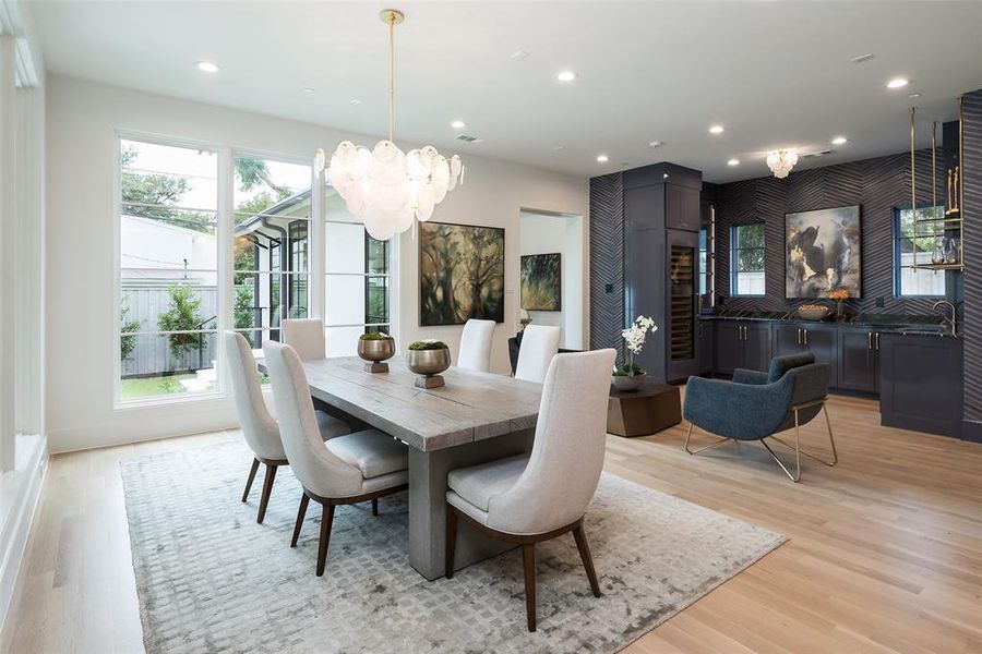 Dining room featuring sink and light hardwood / wood-style flooring