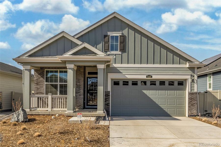 Front exterior of a new home in Green Valley Ranch Active Adult, Aurora, CO, highlighting curb appeal (Image 23).