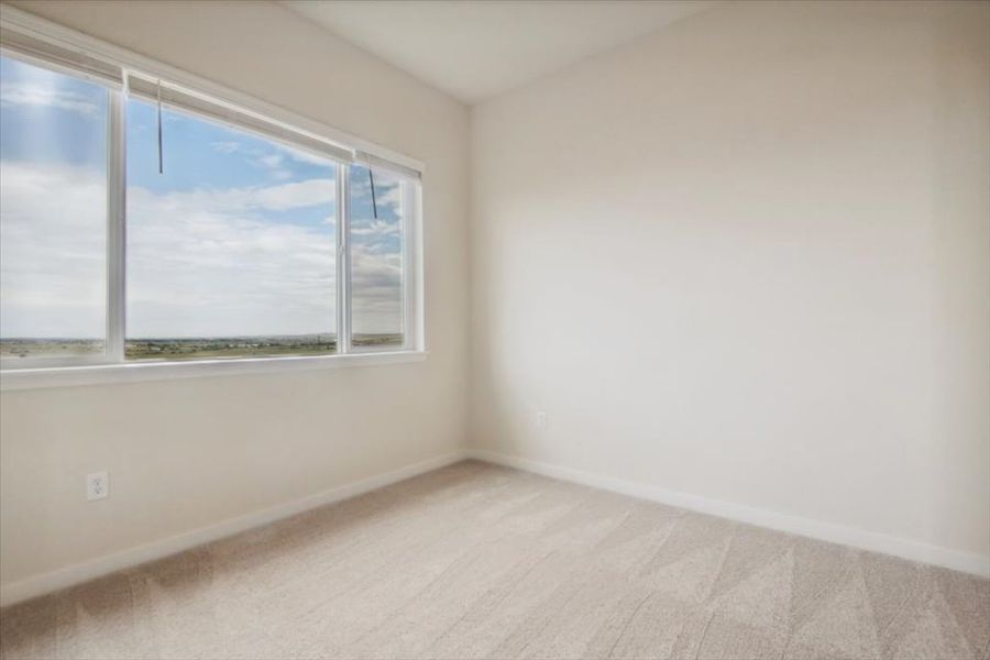 A room with a window and a white wall. A room with a window and a white wall.