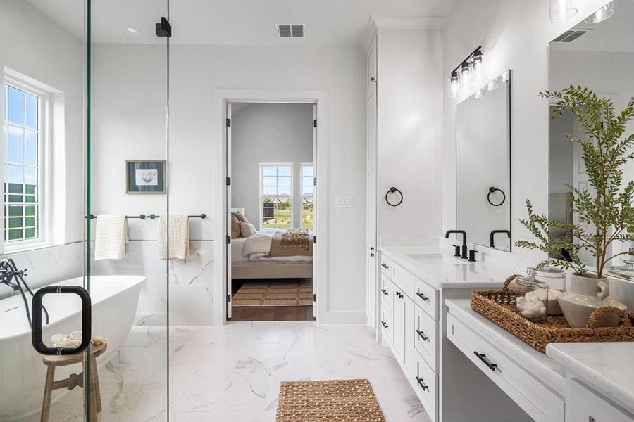 Ensuite bathroom with a freestanding tub, double vanity, and a walk in shower Ensuite bathroom with a freestanding tub, double vanity, and a walk in shower