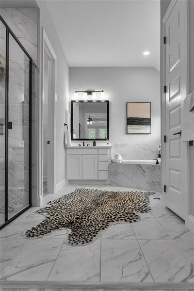 Full bathroom with a marble finish shower, light marble finish flooring, vanity, and recessed lighting Full bathroom with a marble finish shower, light marble finish flooring, vanity, and recessed lighting