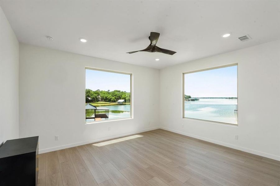 2nd floor water front primary suite with access to patio & large bathroom.