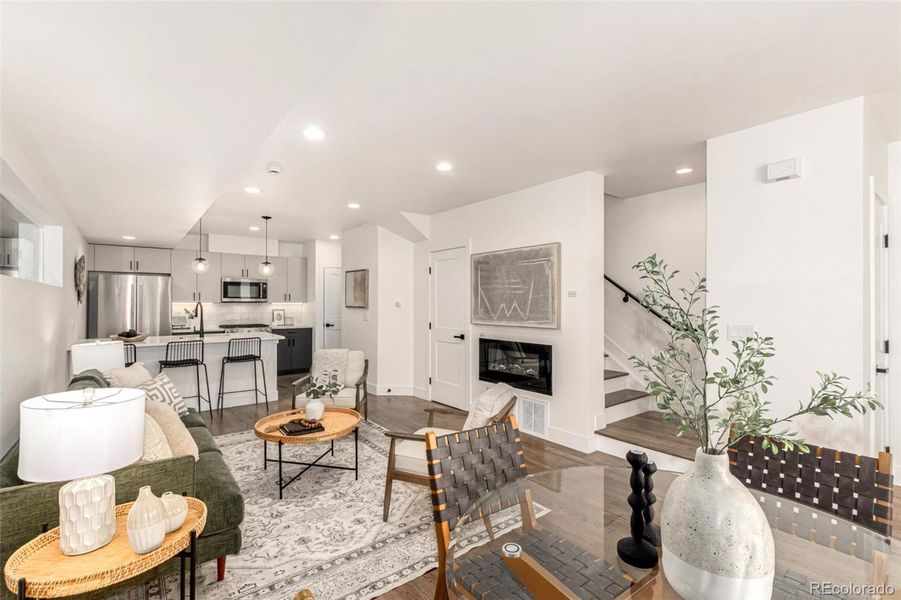 Open plan living, dining and kitchen, with half bath and coat closet on main floor