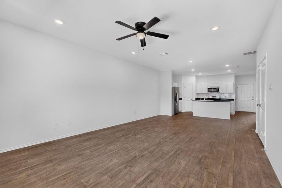 Crisp white walls complement the warm wood flooring throughout this open living and dining area. Crisp white walls complement the warm wood flooring throughout this open living and dining area.