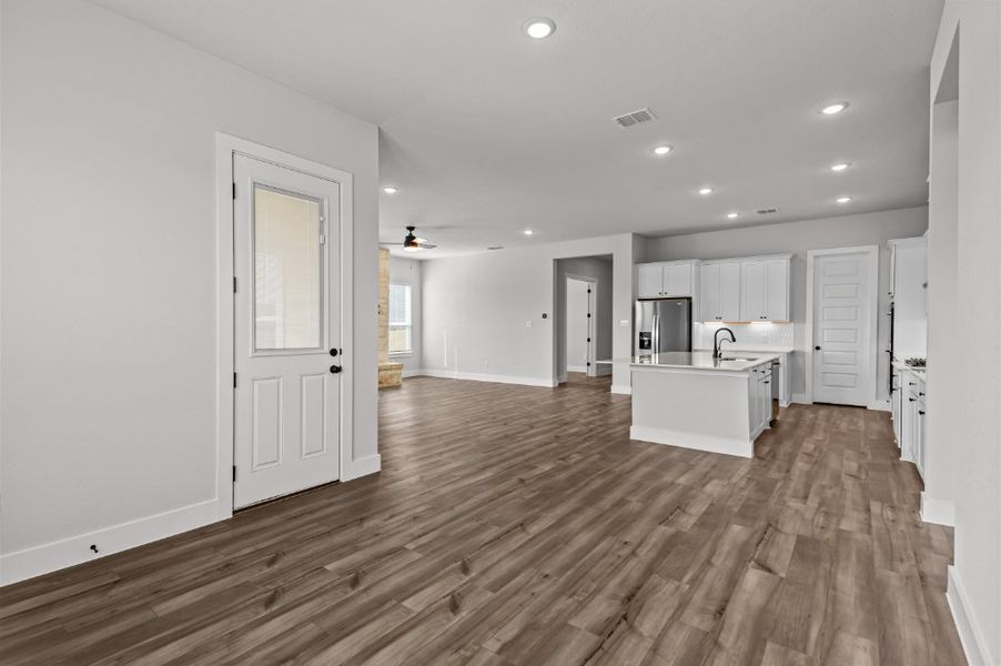 A large kitchen with white cabinets.