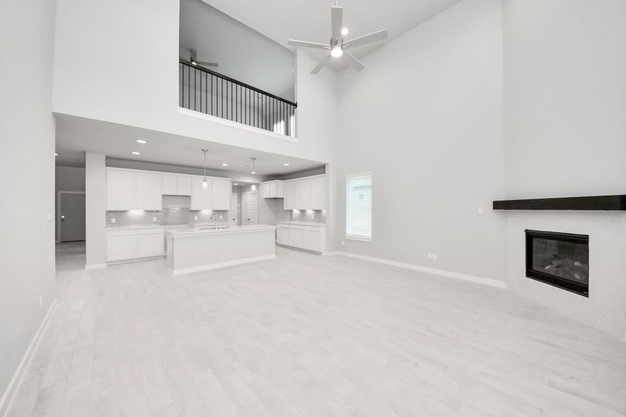Gather the family and guests together in your lovely living room! Featuring soaring high ceilings, recessed lighting, ceiling fan, custom paint, gorgeous floors, and large windows that provide plenty of natural lighting throughout the day. Sample photo of completed home with similar floor plan. Actual colors and selections may vary. Gather the family and guests together in your lovely living room! Featuring soaring high ceilings, recessed lighting, ceiling fan, custom paint, gorgeous floors, and large windows that provide plenty of natural lighting throughout the day. Sample photo of completed home with similar floor plan. Actual colors and selections may vary.
