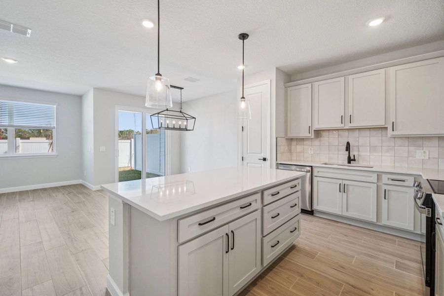 Large kitchen island overlooks the open first-floor living area