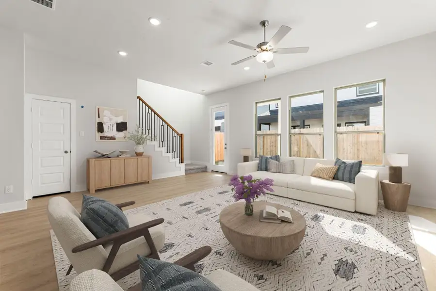 This open and airy living space showcases beautiful natural light through large windows, highlighting the clean modern design. The neutral palette and recessed lighting enhance the bright, welcoming feel, while the seamless flow to the kitchen and dining areas creates a spacious layout ideal for everyday living and entertaining. This open and airy living space showcases beautiful natural light through large windows, highlighting the clean modern design. The neutral palette and recessed lighting enhance the bright, welcoming feel, while the seamless flow to the kitchen and dining areas creates a spacious layout ideal for everyday living and entertaining.