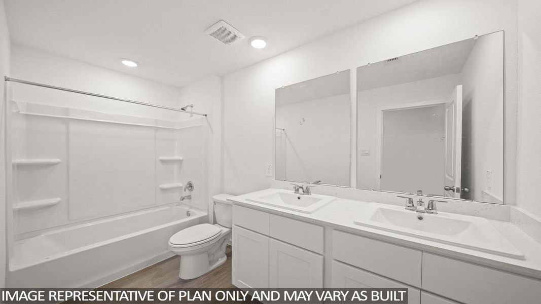 Full bathroom with double vanity, shower / washtub combination, and light wood-type flooring
