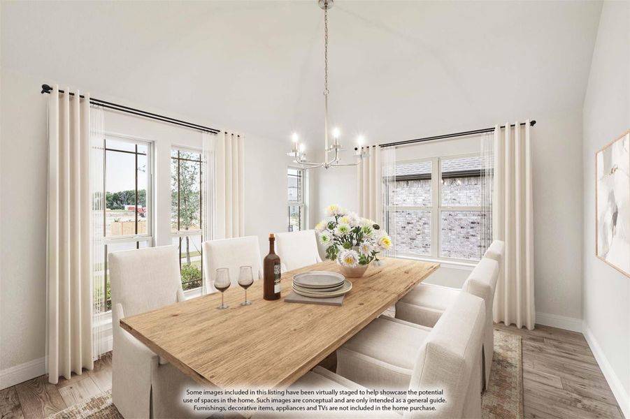 Dining room with wood table, white upholstered chairs, chandelier, and vaulted ceiling