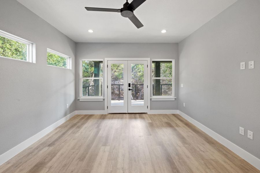 Primary Bedroom leads out to the porch through french doors.