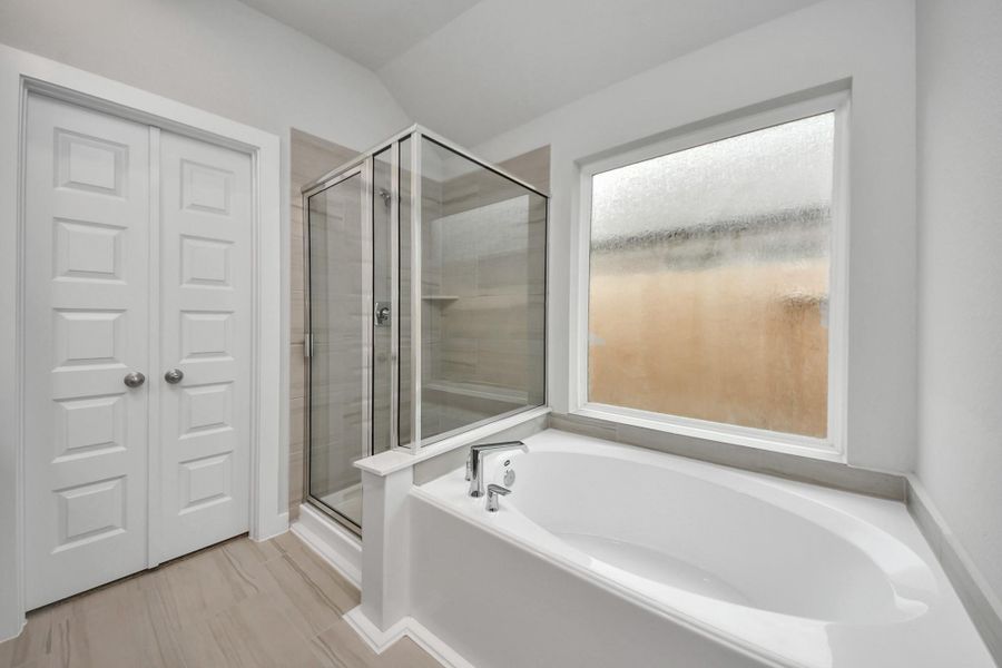 Indulge in a spa-like retreat within the confines of this primary bathroom.Delight in a spacious walk-in shower enveloped in stylish tile surround, unwindin a separate garden tub adorned with custom detailing. Sample photo of completed home with similar floor plan. Actual colors and selections may vary. Indulge in a spa-like retreat within the confines of this primary bathroom.Delight in a spacious walk-in shower enveloped in stylish tile surround, unwindin a separate garden tub adorned with custom detailing. Sample photo of completed home with similar floor plan. Actual colors and selections may vary.